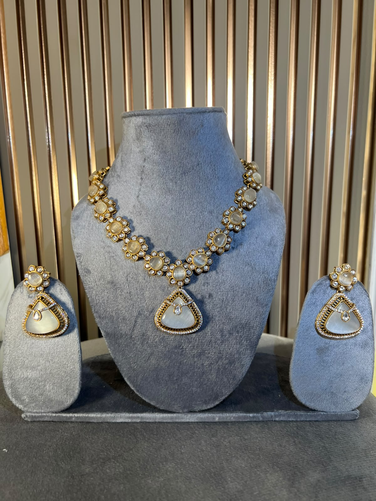 White Monalisa stone and moissanite pendant necklace set with floral motifs, a teardrop pendant and matching earrings