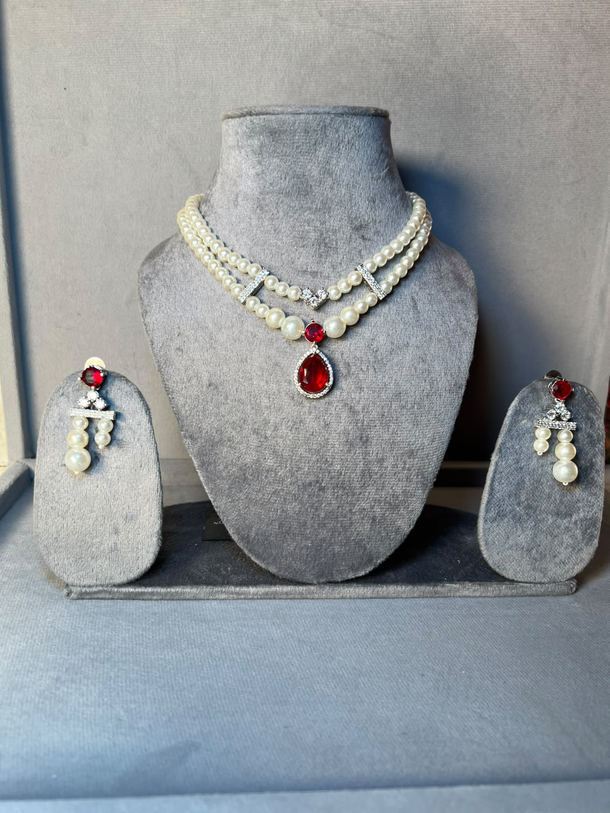 Pearl necklace set with red stone pendant and matching earrings